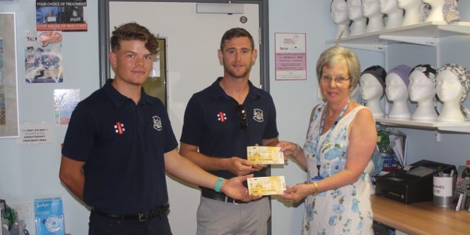 Brandon and Ian hand over cricket tickets to Yvonne Kimber in the information centre